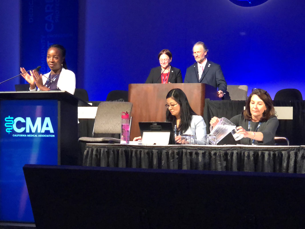 Dr. Lase Ajayi leads discussion of a Major Topic report in front of the Annual Assembly of the California Medical Association.